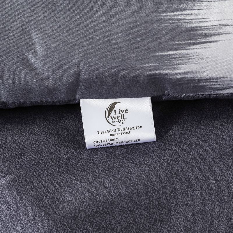 Close-up of the LiveWell Bedding satin label sewn into a grey comforter