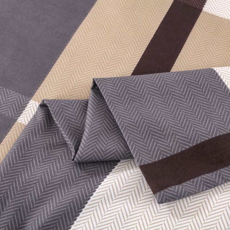Folded Belle Haven sheet in a grey herringbone print with a brown stripe