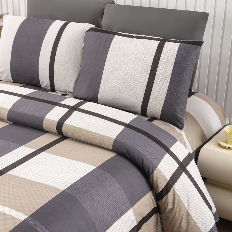 Belle Haven striped sheets and pillowcases on a bed beside a nightstand